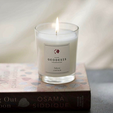 Load image into Gallery viewer, Geodesis scented candle on a book
